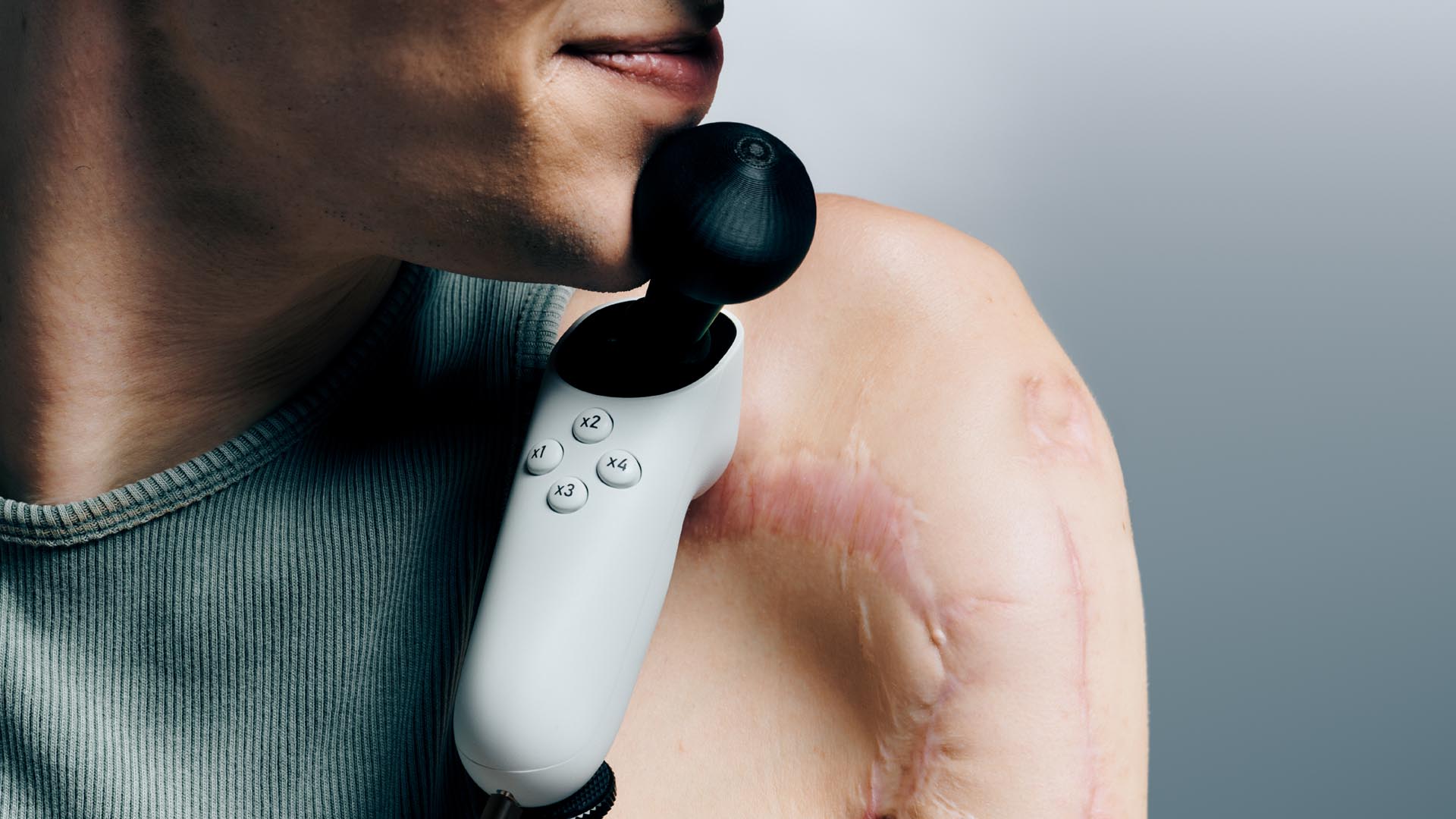 A person operating an Xbox Adaptive Joystick with their chin.